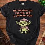 Black t-shirt with "ME WAKING UP FOR THE JOB I PRAYED FOR" text and goblin character.
