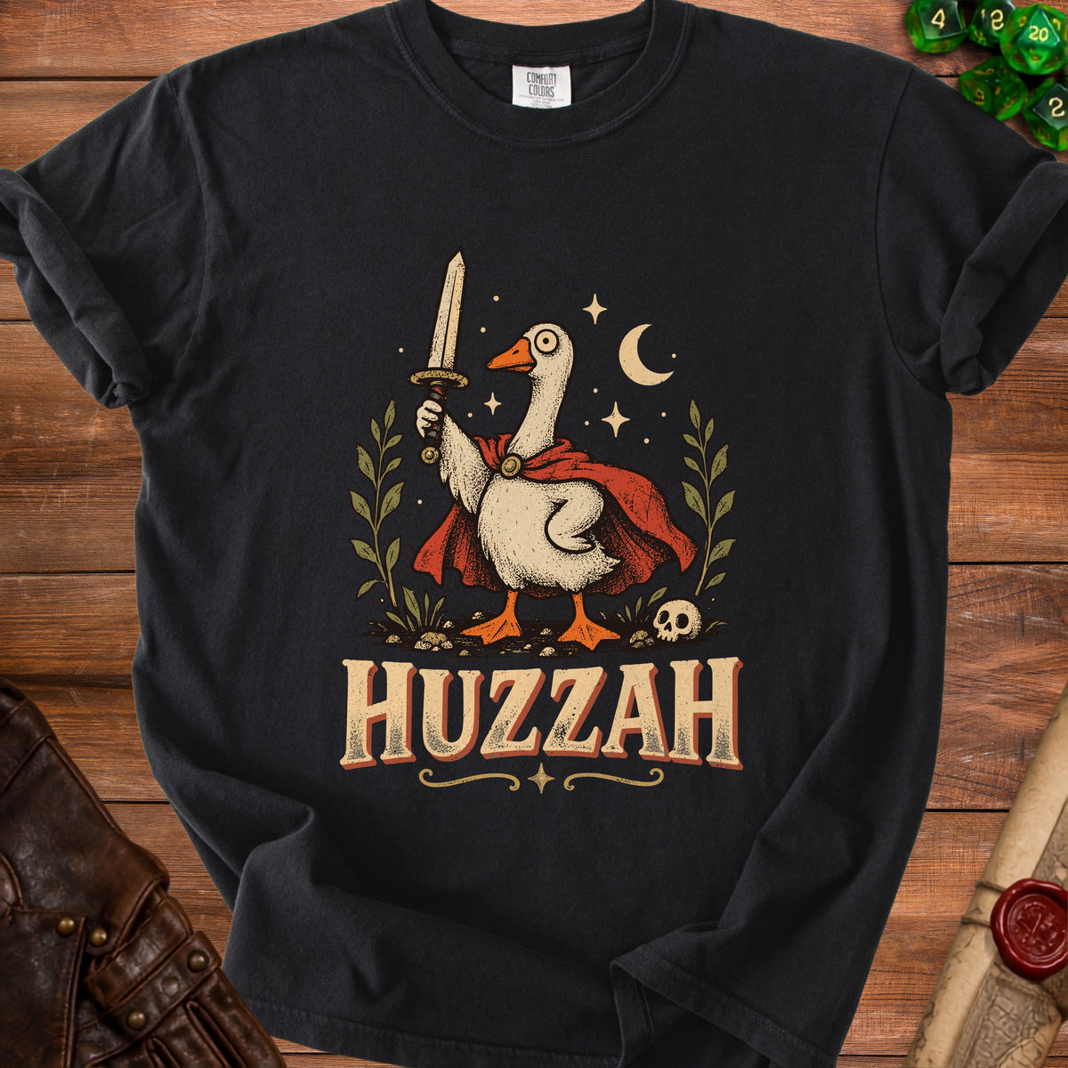 Goose warrior holding sword with "HUZZAH" text and skull on black t-shirt.