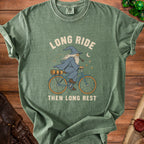 Green t-shirt with wizard on bicycle graphic and text "LONG RIDE THEN LONG REST".