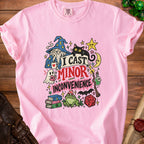 Pink t-shirt with cartoon wizard, cat, and text "I CAST MINOR INCONVENIENCE".