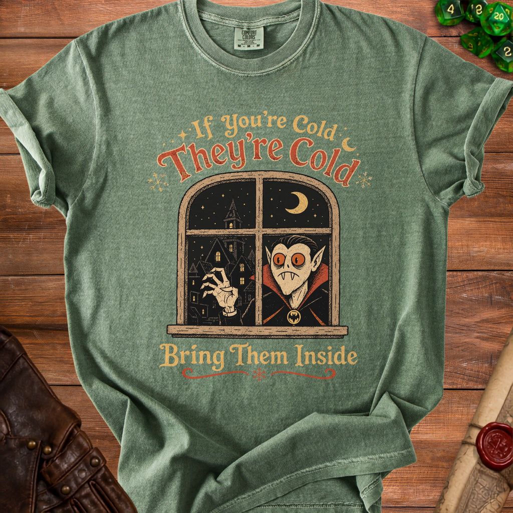 Green t-shirt with a vampire in a window and text "If you're cold, they're cold, bring them inside."
