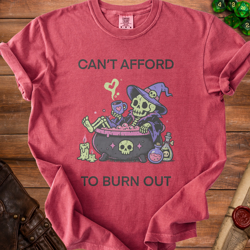 Red t-shirt with skeleton witch design and text "CAN'T AFFORD TO BURN OUT".