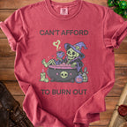 Red t-shirt with skeleton witch design and text "CAN'T AFFORD TO BURN OUT".