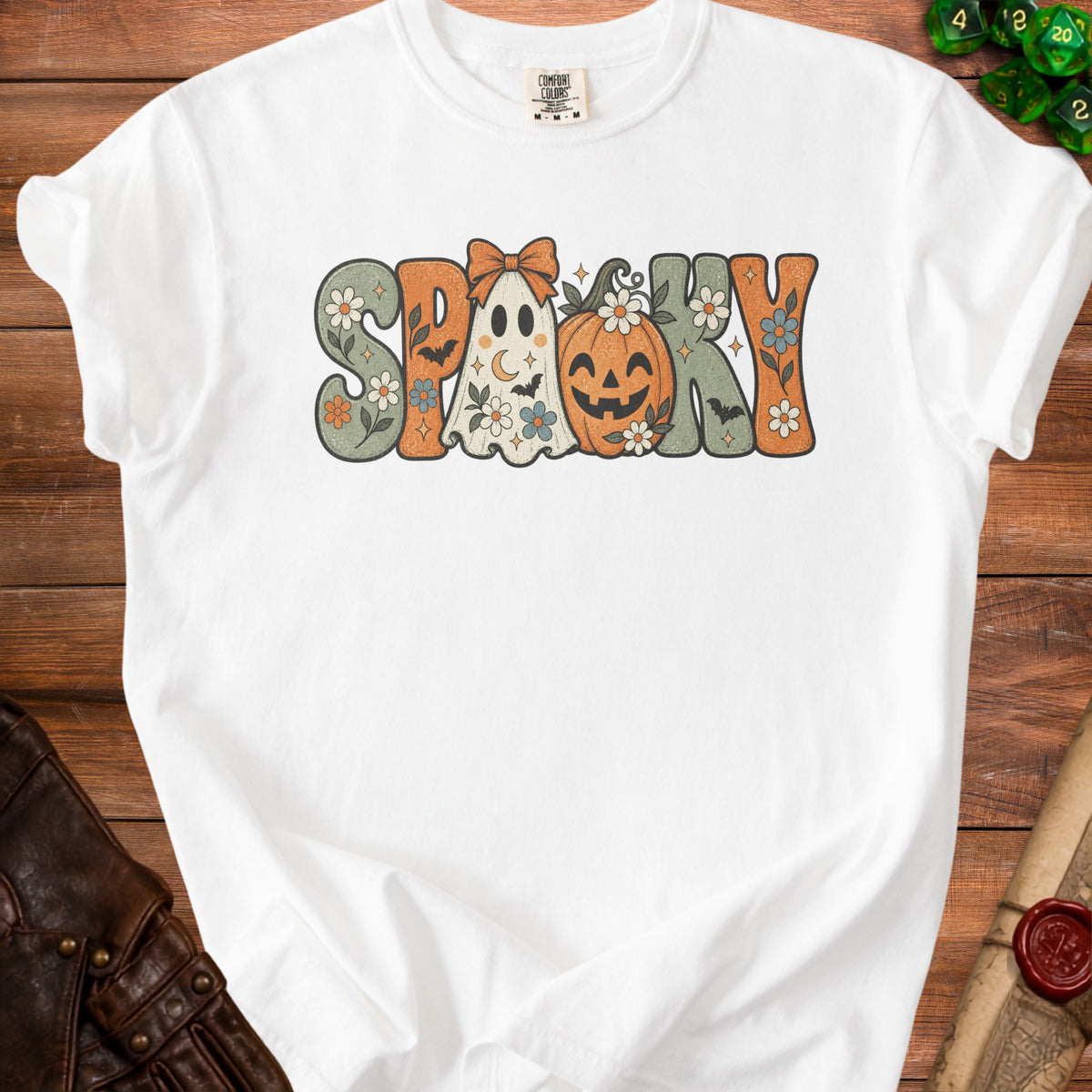 White t-shirt with "Spooky" text featuring a ghost, pumpkin, bats, and flowers.