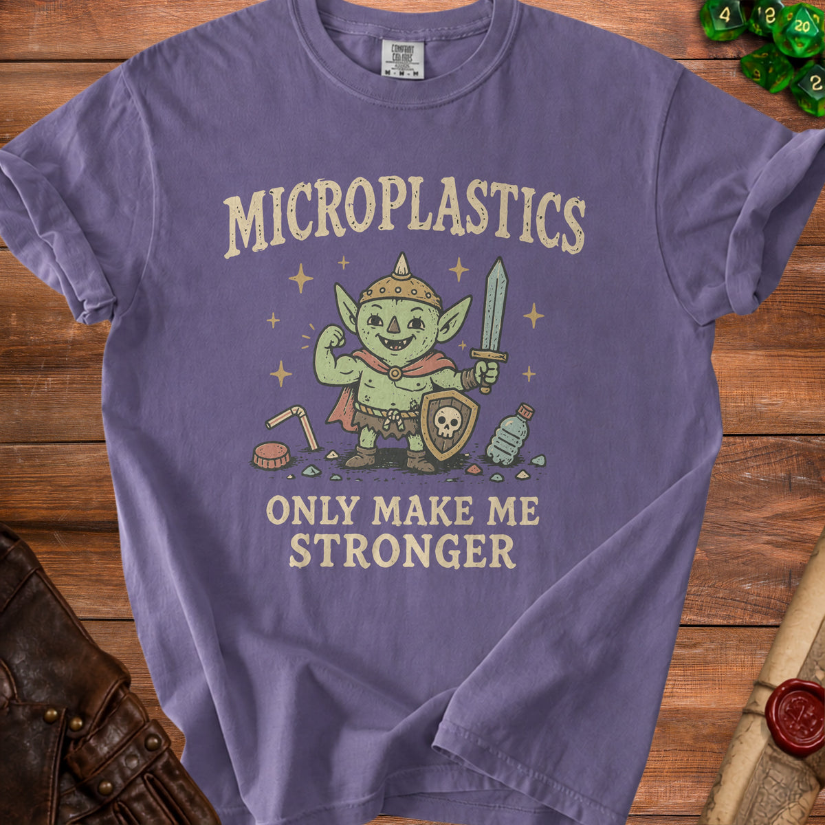 Purple t-shirt with goblin character and text "Microplastics Only Make Me Stronger".