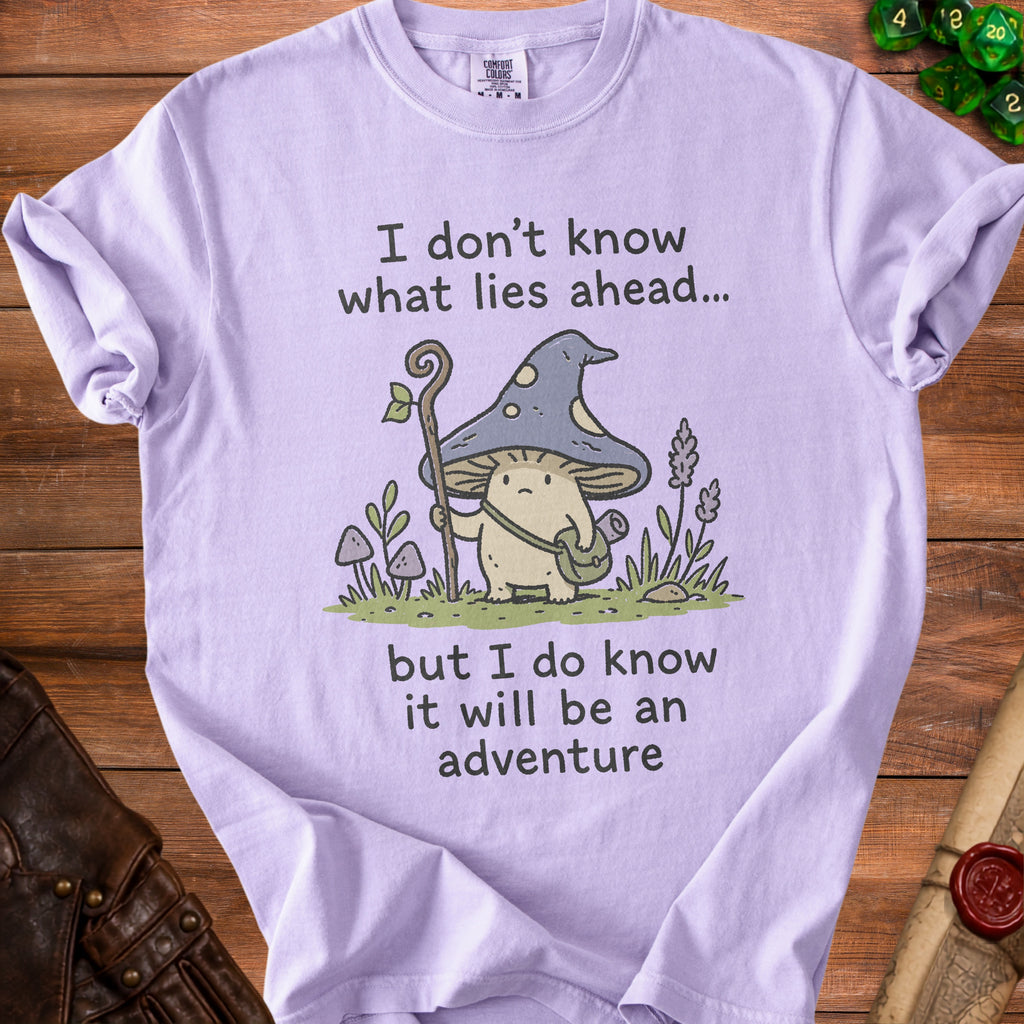 Purple t-shirt with a mushroom adventurer graphic and text "I don't know what lies ahead... but I do know it will be an adventure".
