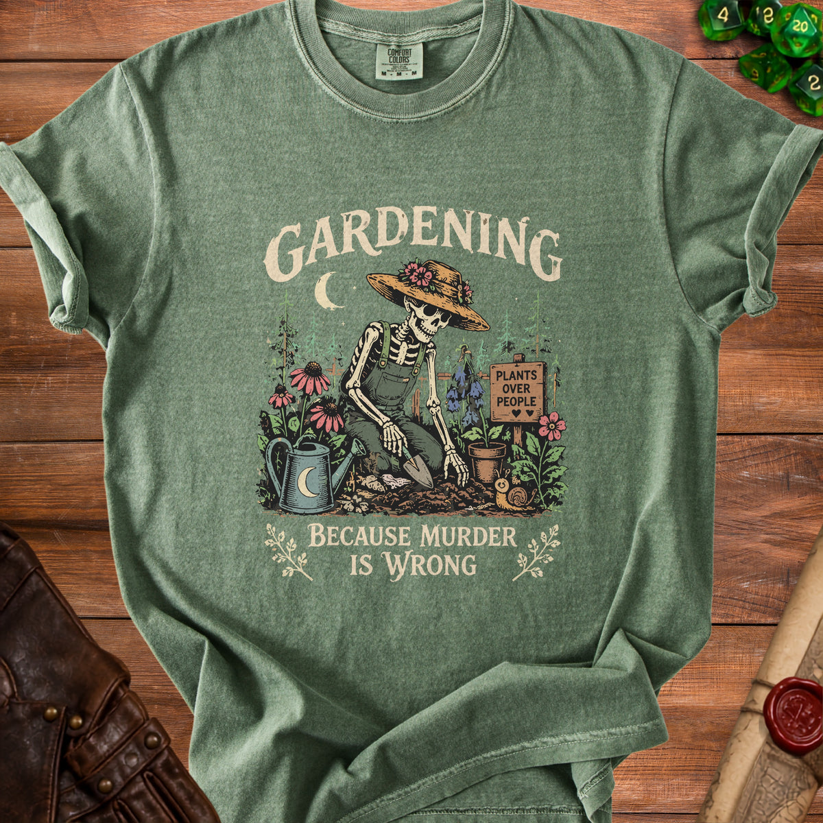 Green t-shirt with skeleton gardening graphic and text "Gardening Because Murder Is Wrong".