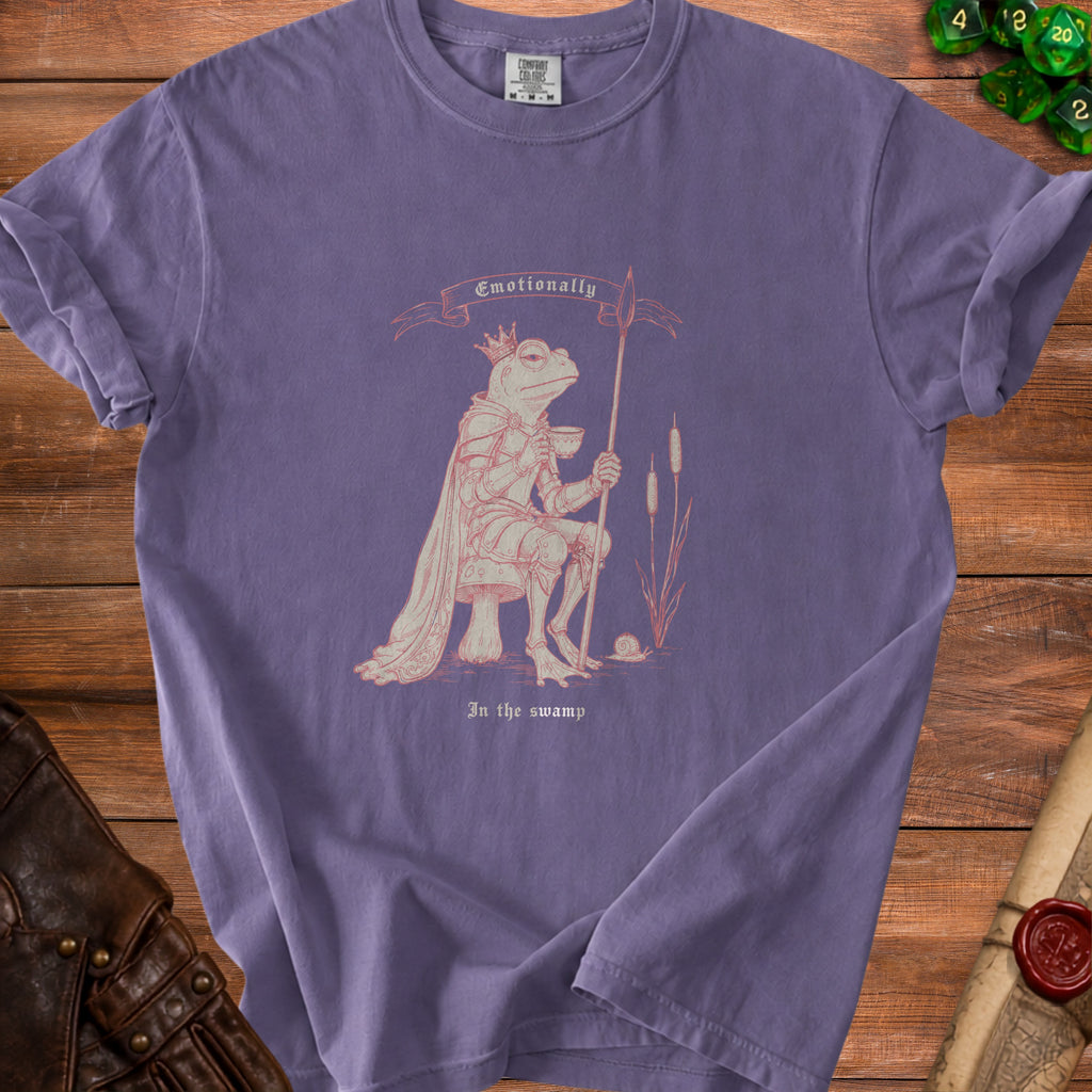 Purple t-shirt with a knightly frog holding a tea cup and spear with text "Emotionally" and "In the swamp."