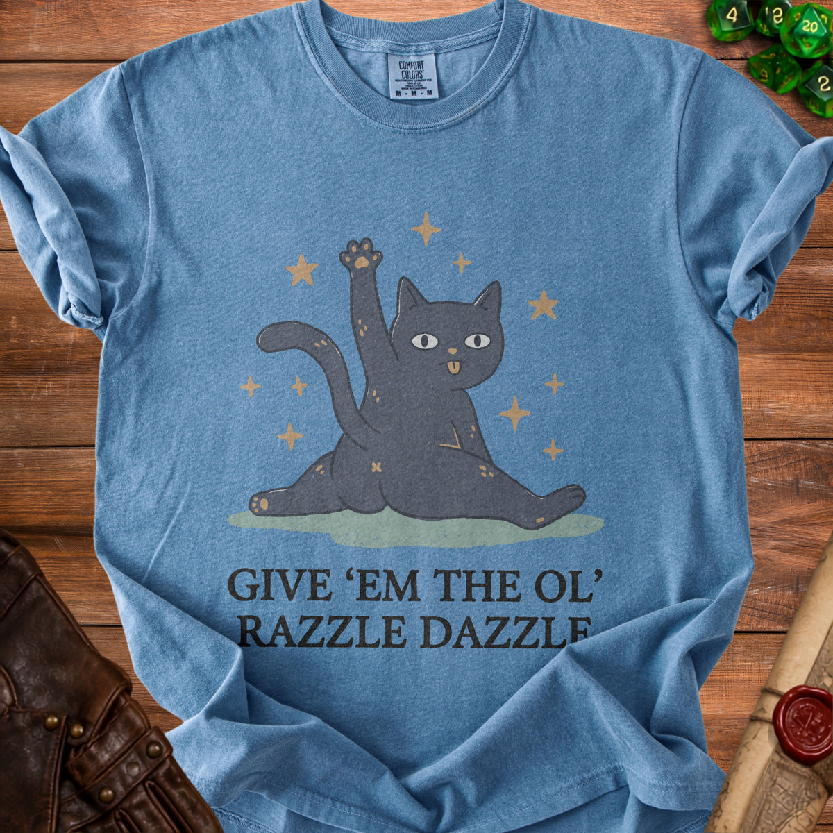 Blue t-shirt with a gray cat graphic and text "GIVE 'EM THE OL' RAZZLE DAZZLE".