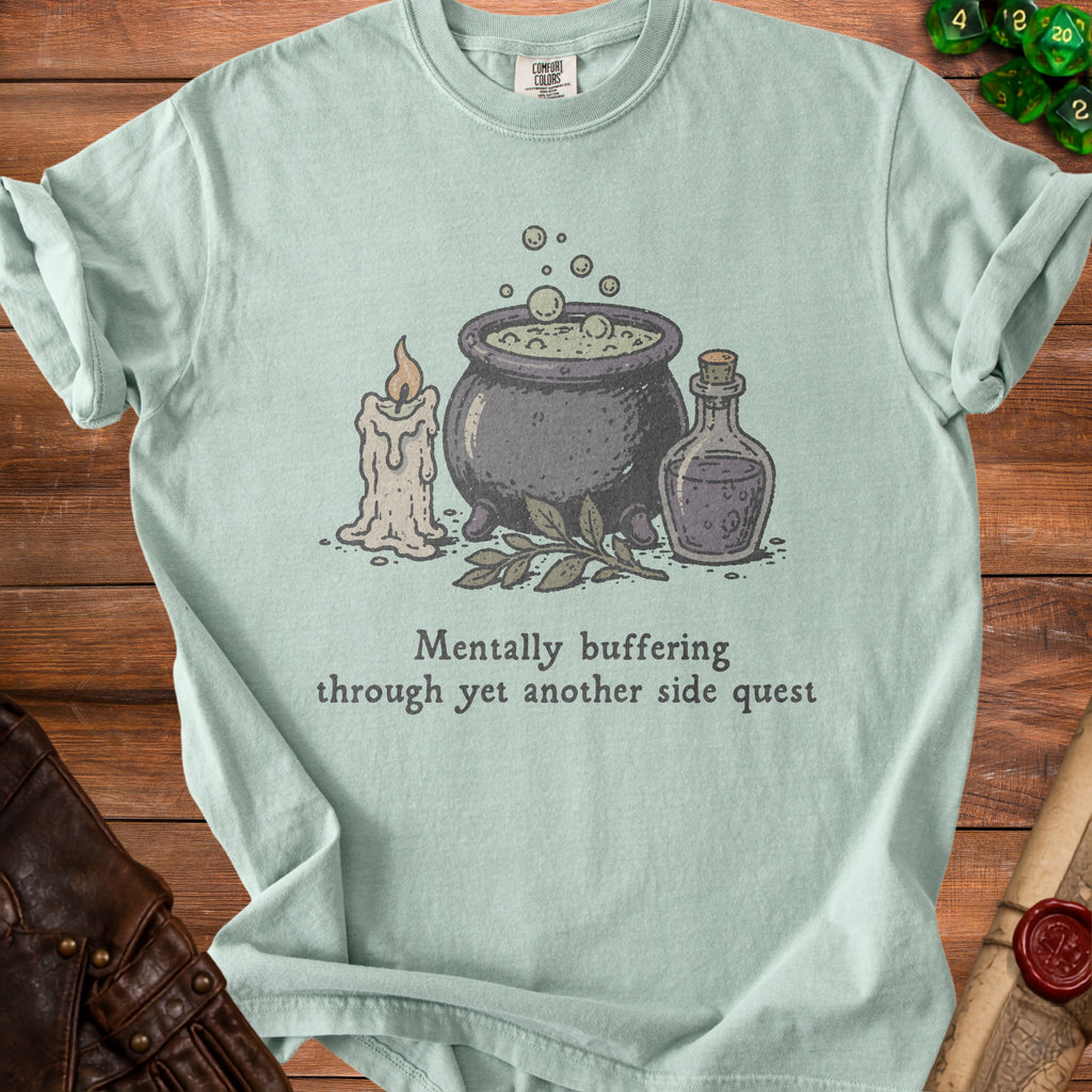 Light green t-shirt with witch's cauldron, candle, potion, and text.