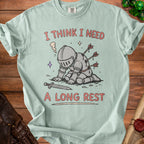 Mint green t-shirt with cartoon knight with arrows and text "I THINK I NEED A LONG REST".