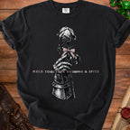 Black t-shirt with a skeletal hand holding a rose with pink bow. Text reads: "HELD TOGETHER BY BOWS & SPITE".