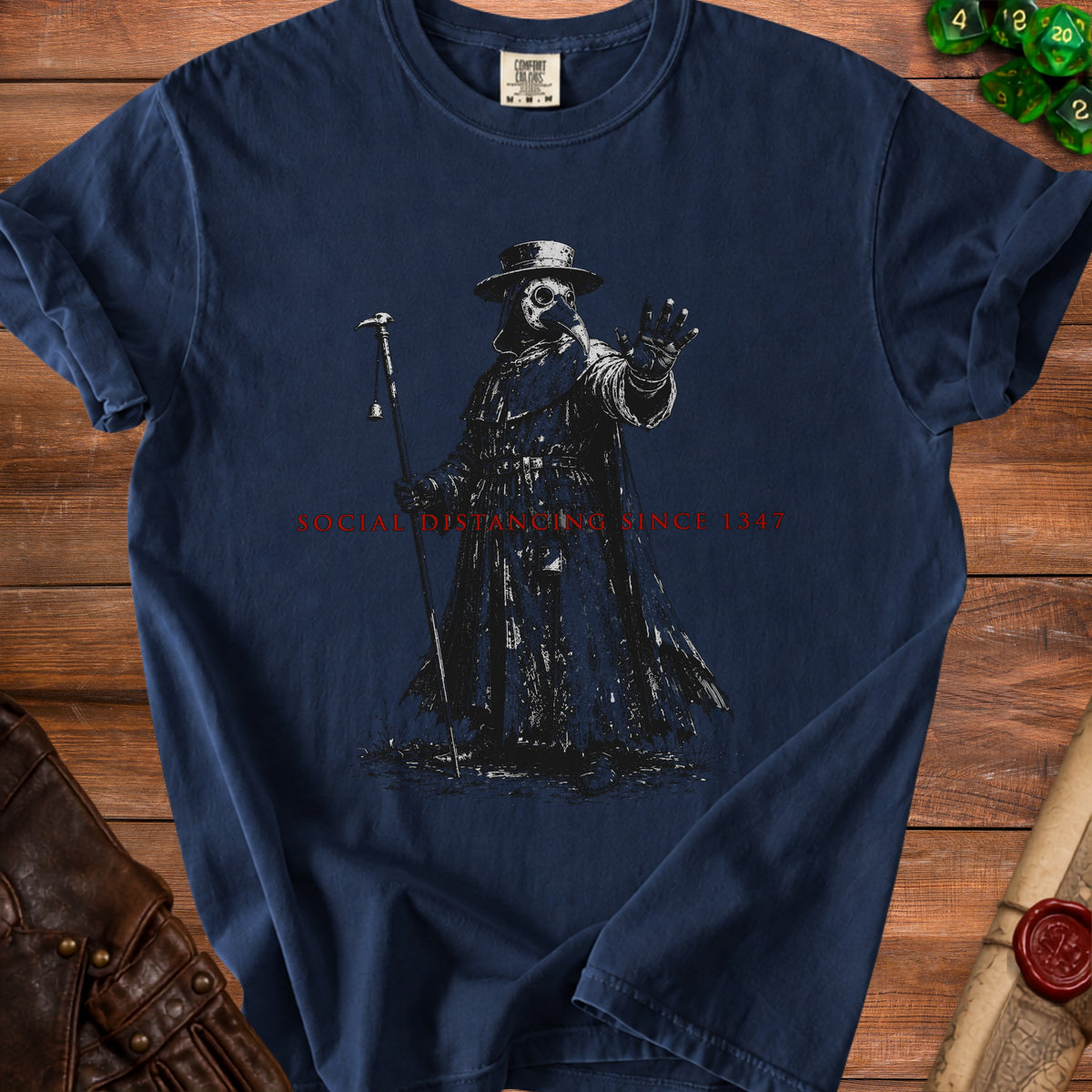 Plague doctor graphic with text "Social Distancing Since 1347" on navy t-shirt.