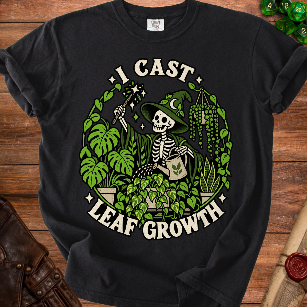 Skeleton witch in a hat waters plants with text "I CAST LEAF GROWTH".