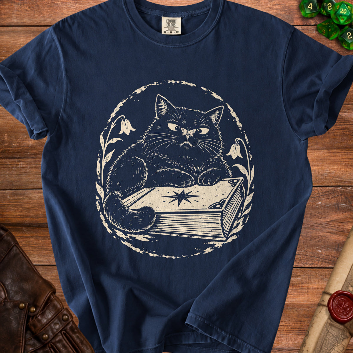 Navy t-shirt with a graphic of a cat sitting on a book.