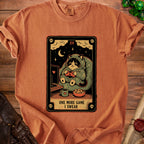 T-shirt with "One More Game I Swear" text and a cat playing video games.