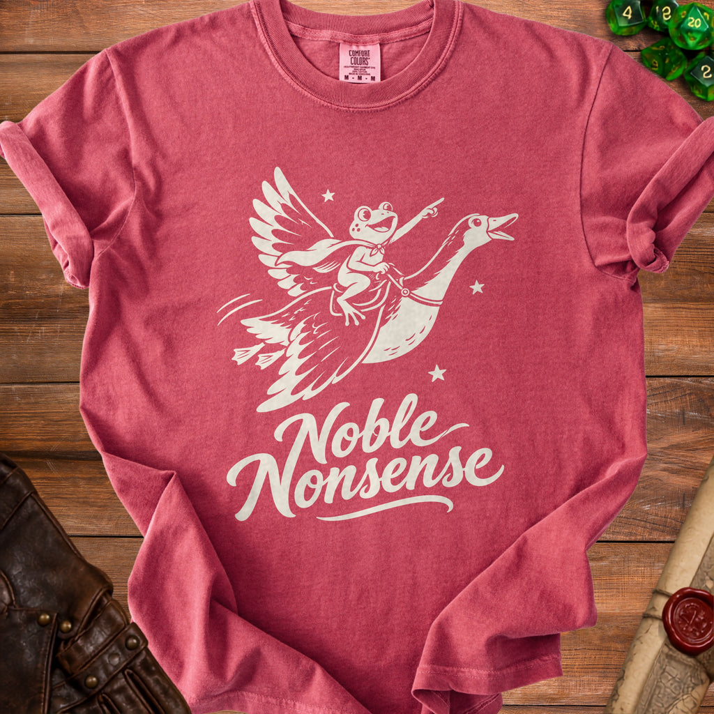A red crewneck t-shirt featuring a white graphic of a frog riding a flying goose with text reading Noble Nonsense.