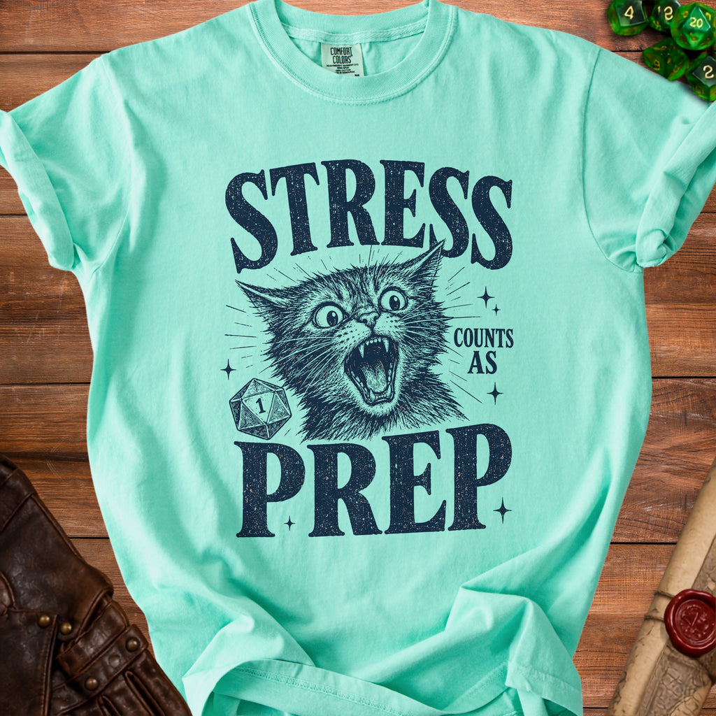 Mint green t-shirt with a distressed graphic of a screaming cat, dice, and text "STRESS COUNTS AS PREP".