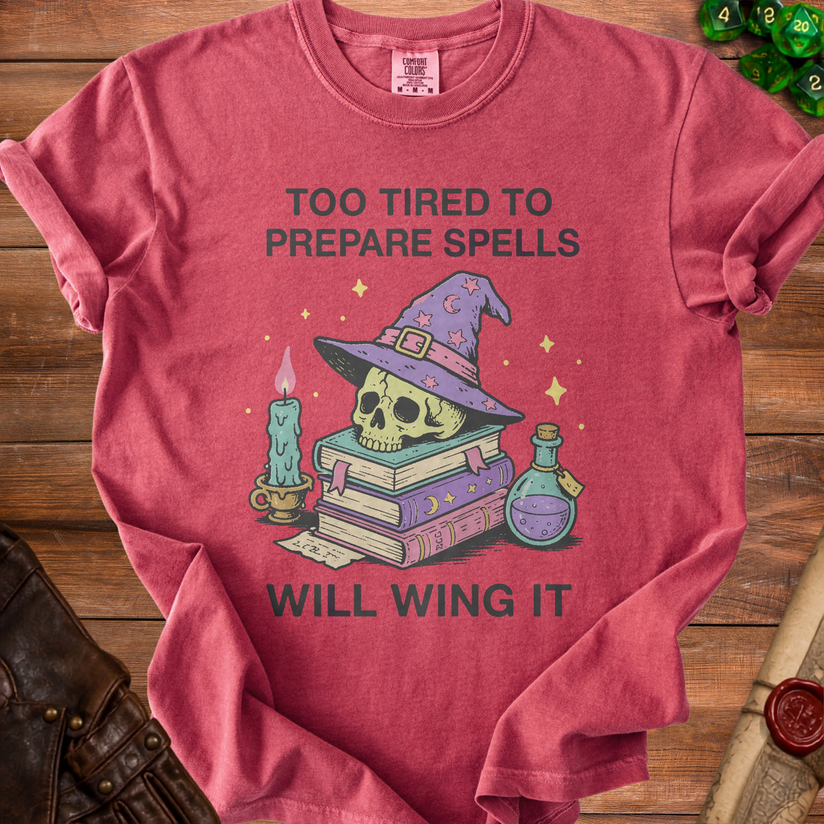 Red t-shirt with skull wearing wizard hat, stack of books, candle, and potion. "Too tired to prepare spells will wing it" text.