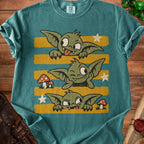 Three green goblins with stars and mushrooms on a teal t-shirt.