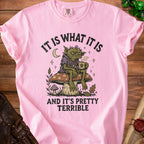 Pink t-shirt with goblin drinking coffee on a mushroom graphic and text.