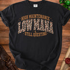 Black t-shirt with "High Maintenance Low Mama Still Questing" text and leopard print.