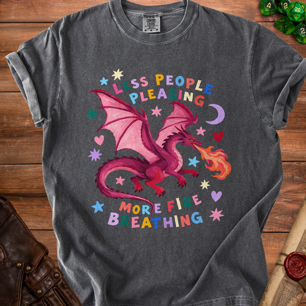 Dark gray t-shirt with a pink dragon breathing fire and the text "less people pleasing, more fire breathing."
