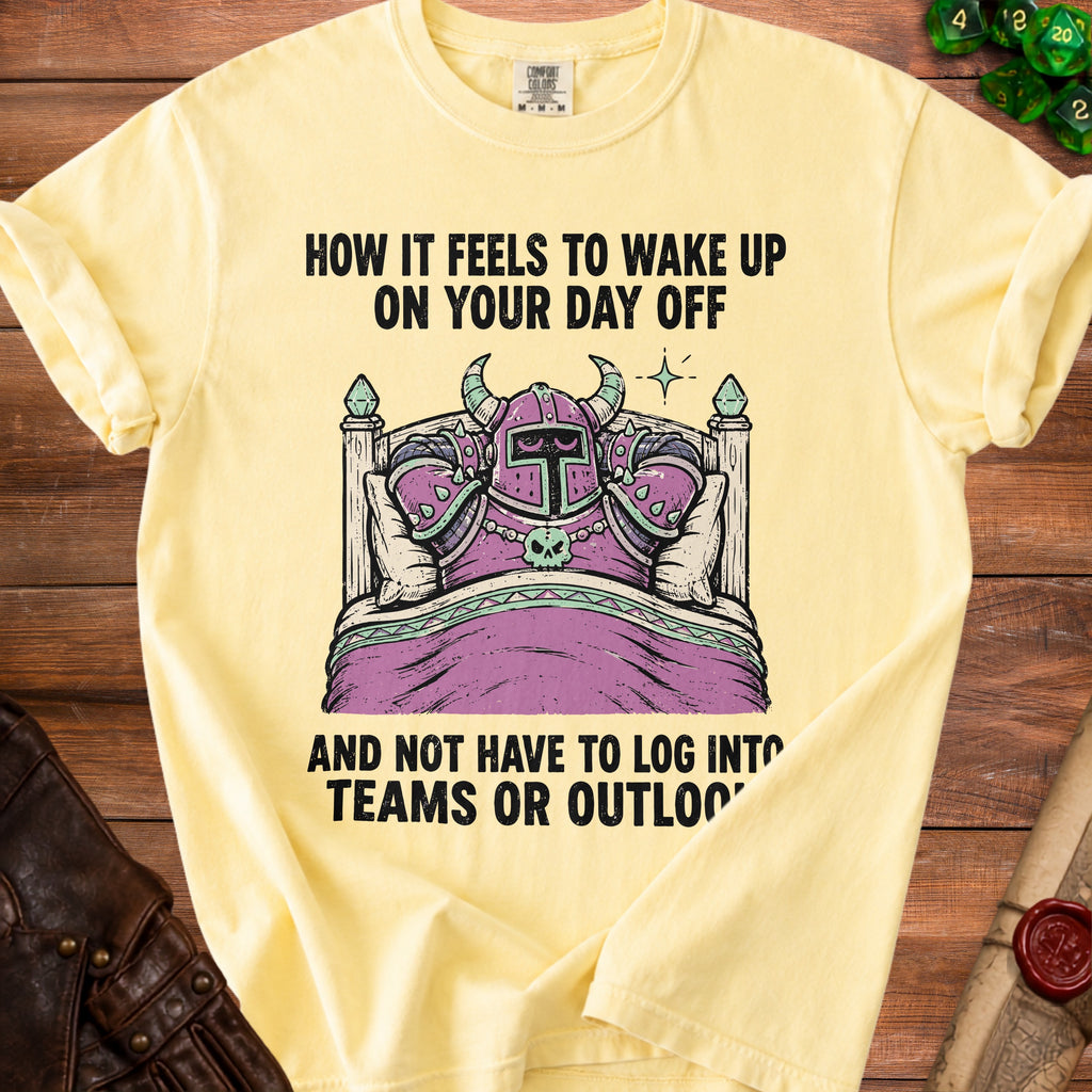 Yellow t-shirt with knight in bed graphic and text "How it feels to wake up on your day off and not have to log into Teams or Outloo".