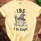 Yellow t-shirt with "IBS I Be Slayin'" text and a wizardly scroll character.