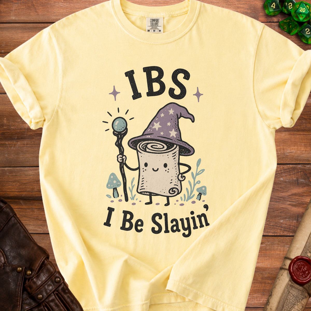Yellow t-shirt with "IBS I Be Slayin'" text and a wizardly scroll character.
