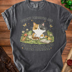 Grey t-shirt with a calico cat, mouse, and bird graphic reading "Today's priorities are peace, snacks, and fewer opinions."