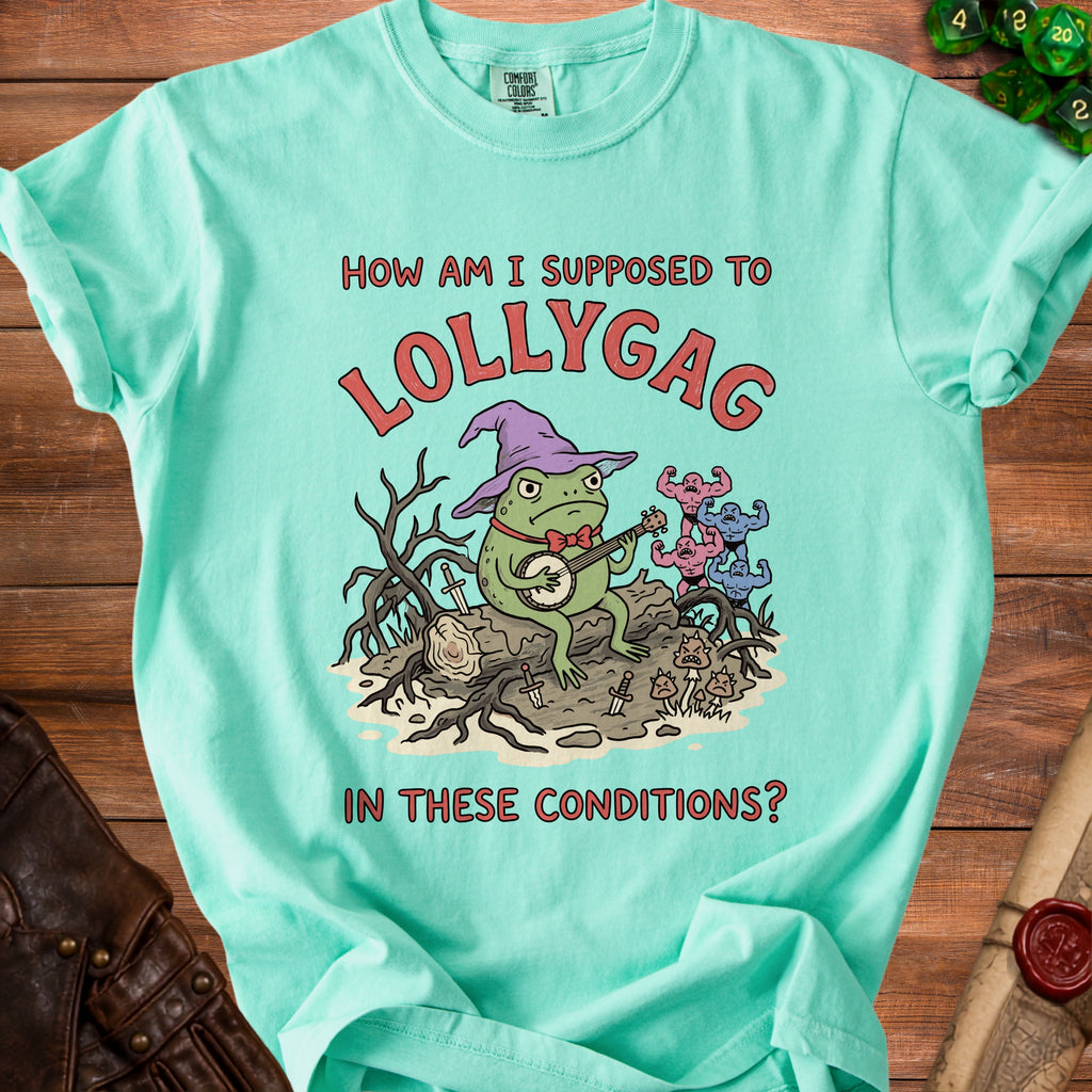 Mint t-shirt with a cartoon frog playing banjo and text: "How am I supposed to lollygag in these conditions?"