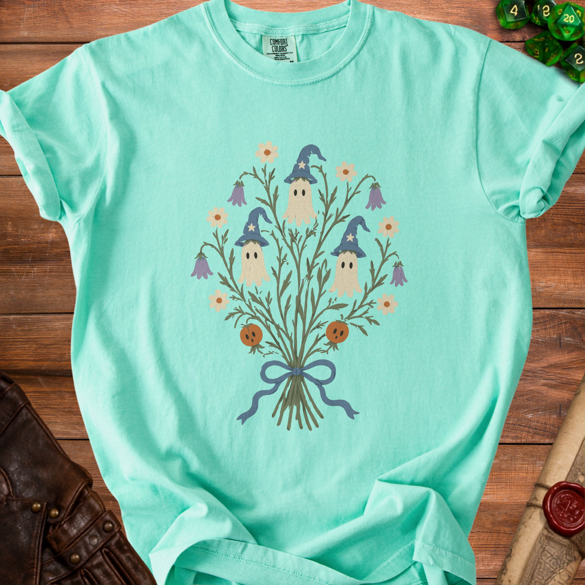 Mint t-shirt with three ghosts in wizard hats and floral elements.