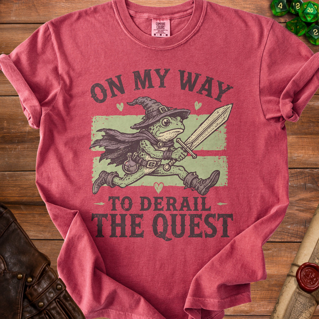 Red t-shirt with a frog wizard holding a sword and the text "On my way to derail the quest".
