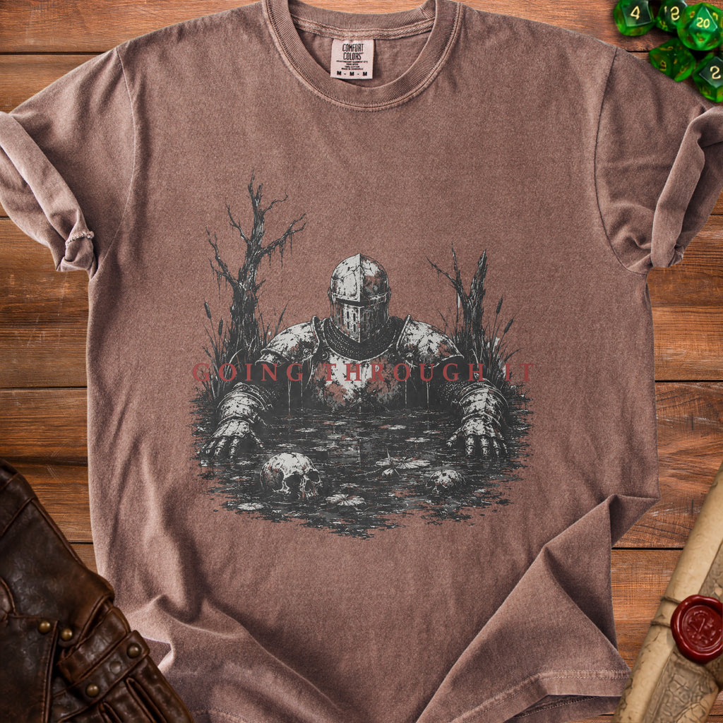 T-shirt with knight in swamp graphic and red text "GOING THROUGH IT".