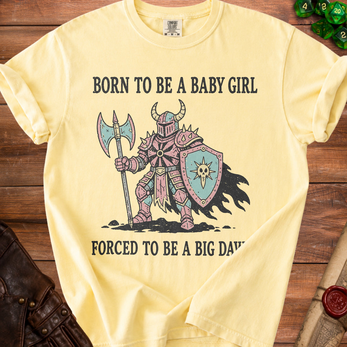 Yellow t-shirt with medieval knight graphic and text "BORN TO BE A BABY GIRL FORCED TO BE A BIG DAD".