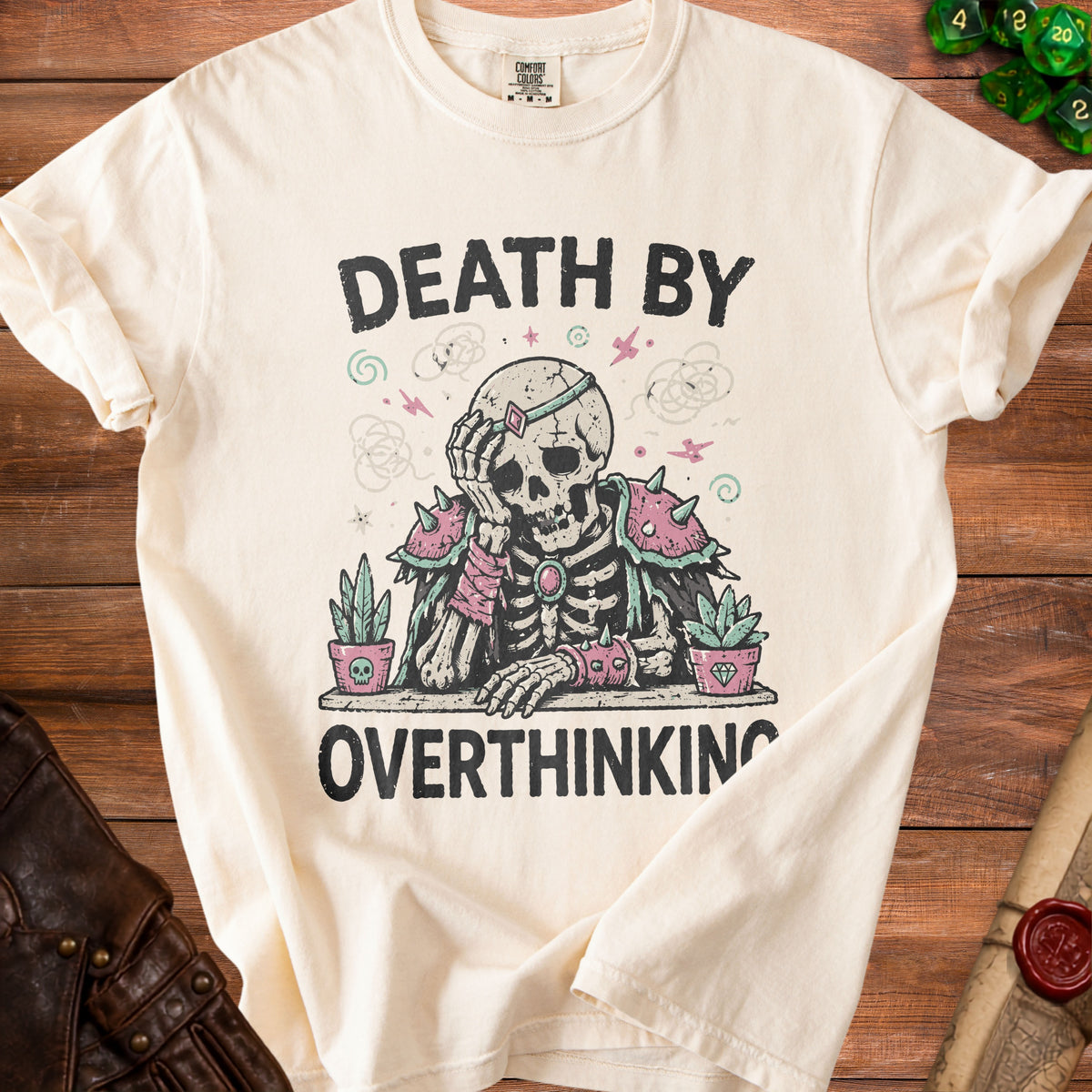 Cream t-shirt with distressed graphic of a skeleton and text "DEATH BY OVERTHINKING".