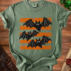 Green t-shirt with distressed orange stripes and three cartoon bats.