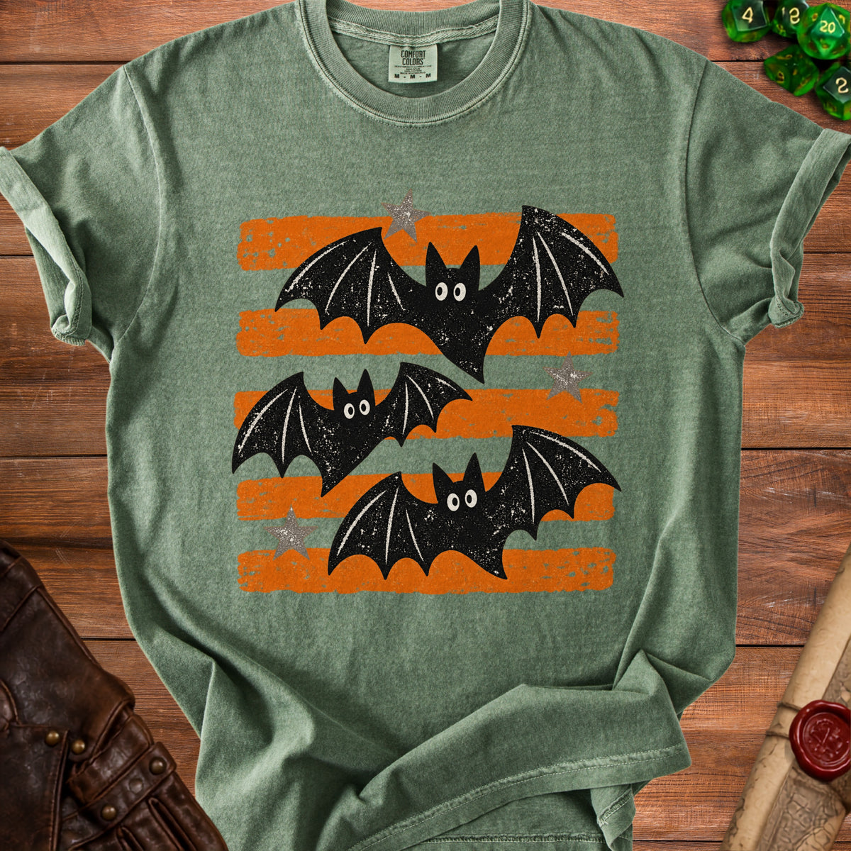 Green t-shirt with distressed orange stripes and three cartoon bats.