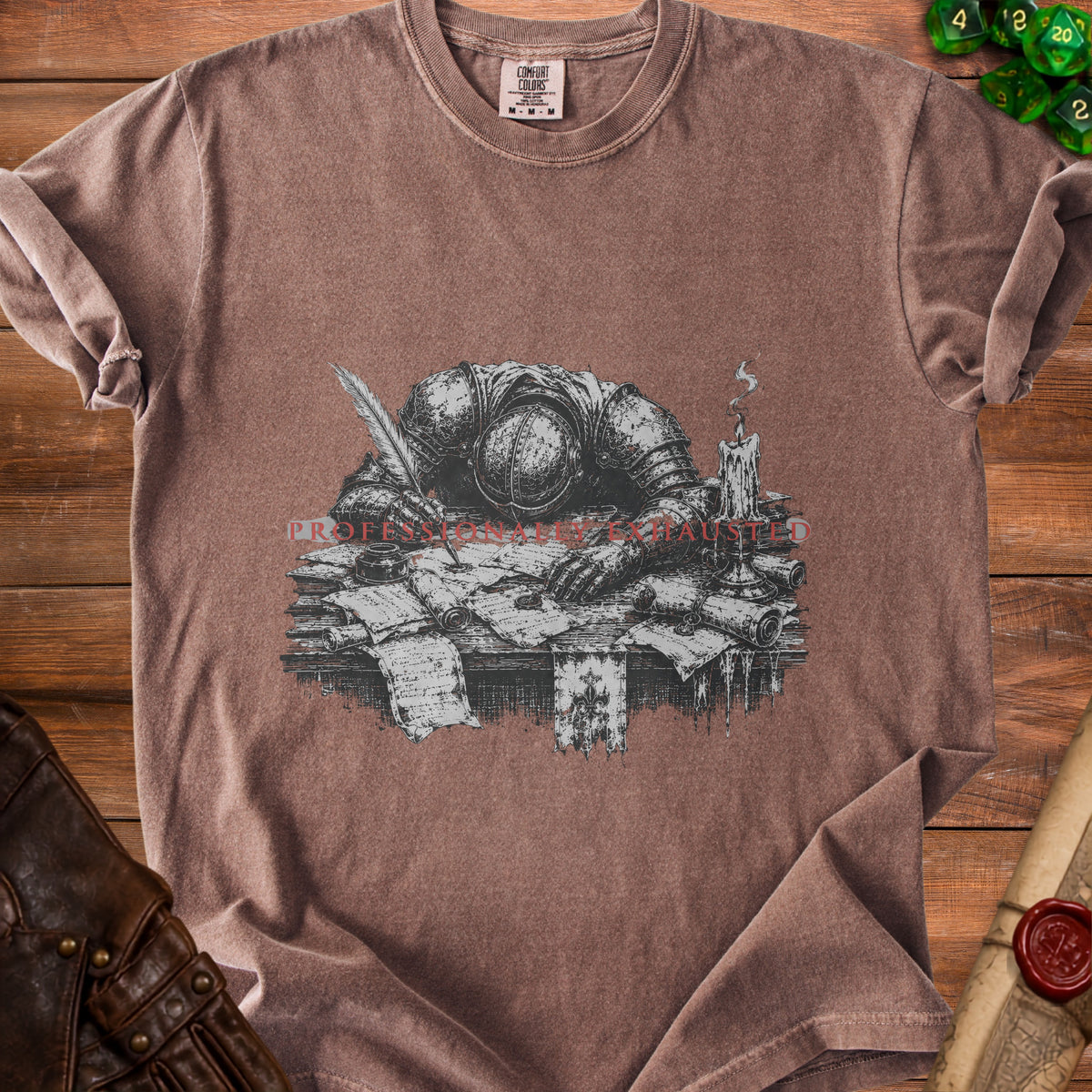T-shirt with a knight slumped over papers, quill, and candle. "Professionally Exhausted" text.