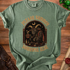 Green t-shirt with graphic of tired goat holding coffee and text "Please Summon Someone Else".