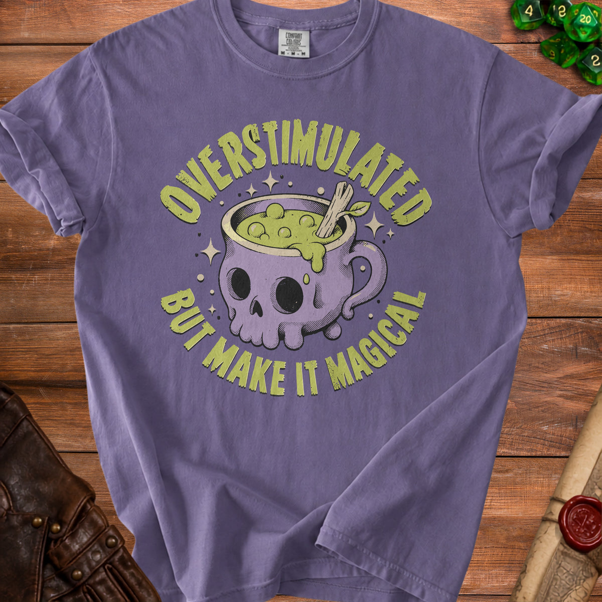 Purple t-shirt with text and graphic of a skull-shaped cauldron.