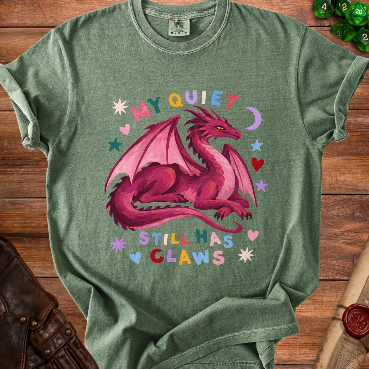 Green t-shirt with a pink dragon and text "MY QUIET STILL HAS CLAWS".