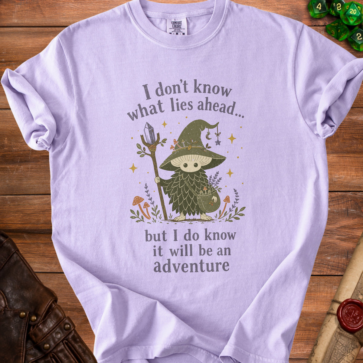 Lavender t-shirt with fairy mushroom illustration and text "I don't know what lies ahead... but I do know it will be an adventure."