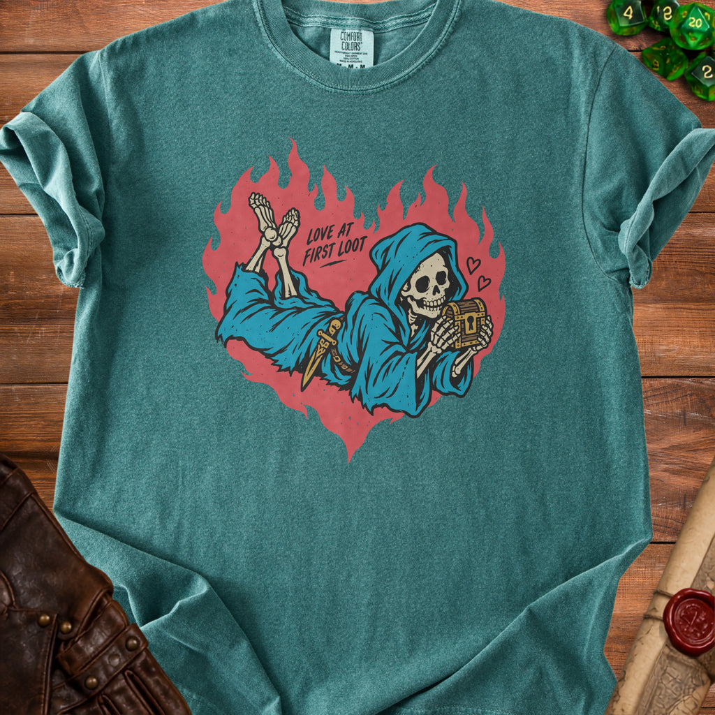 Grim reaper holding chest with text "Love at First Loot" on teal shirt.