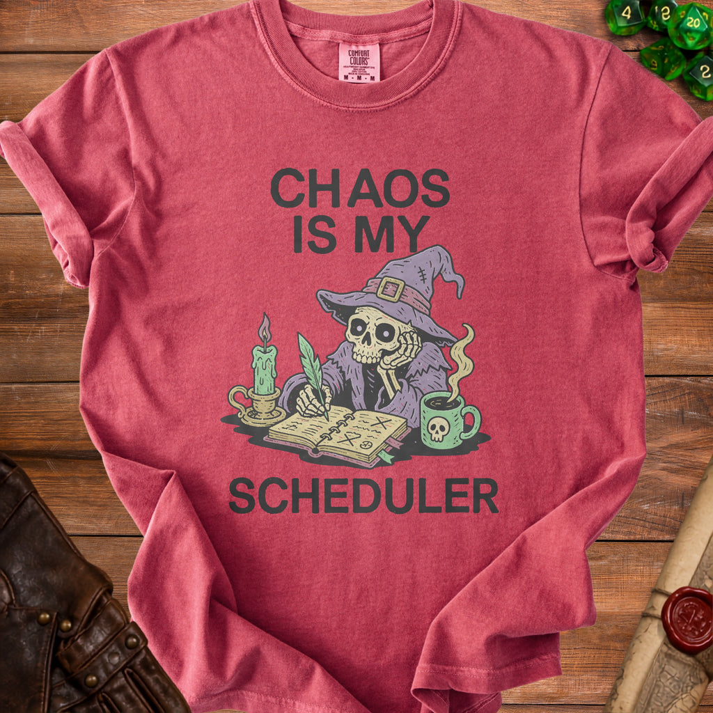 Red t-shirt with "CHAOS IS MY SCHEDULER" text and a skeleton wizard graphic.