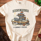 Cream t-shirt with black cat wearing wizard hat, text "HOCUS POCUS I CANNOT FOCUS".