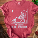 Red t-shirt with white graphic of a knight being led by a goose, with text "MY SQUIRE IS THE PROBLEM".