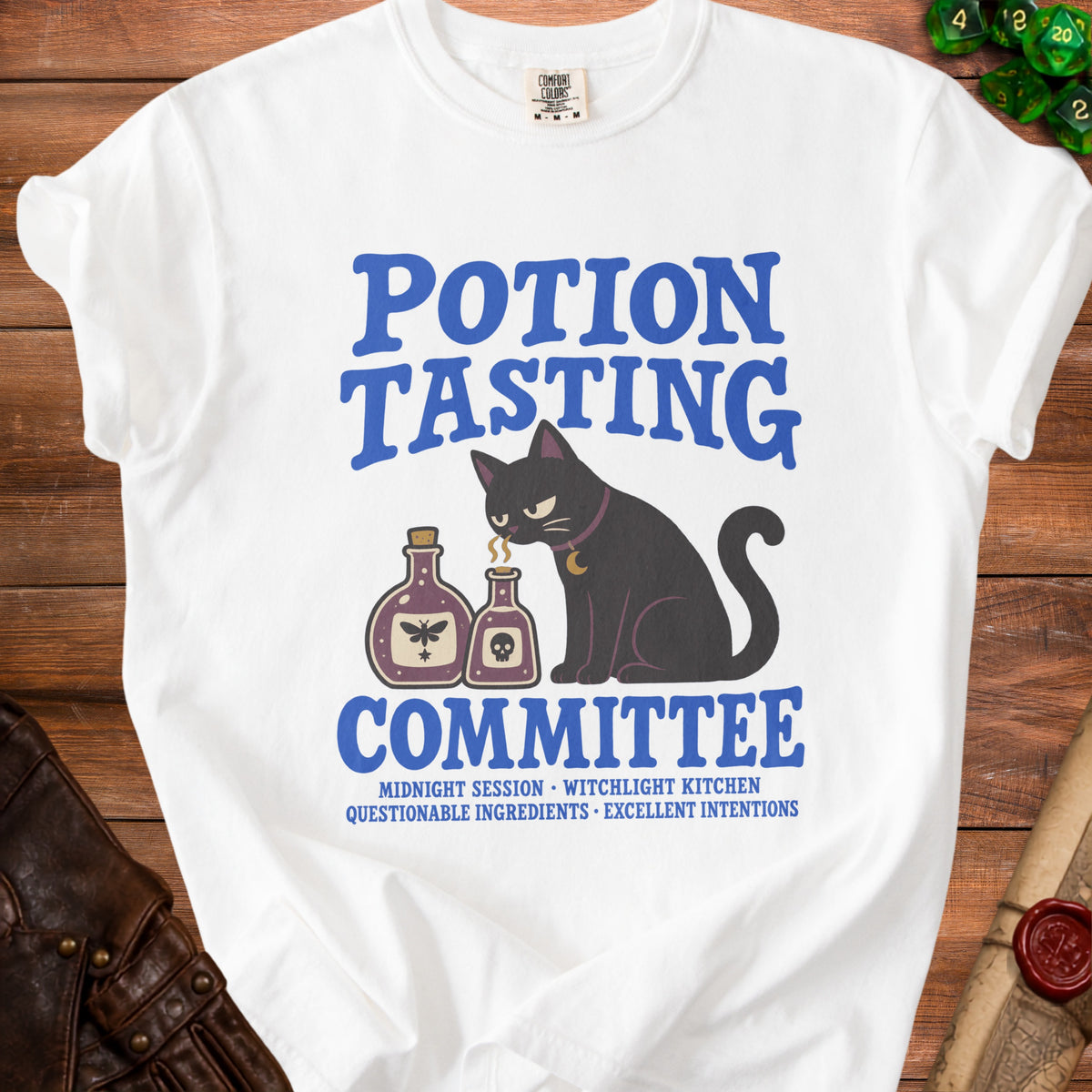 White t-shirt with a black cat and potion bottles, "Potion Tasting Committee" text.