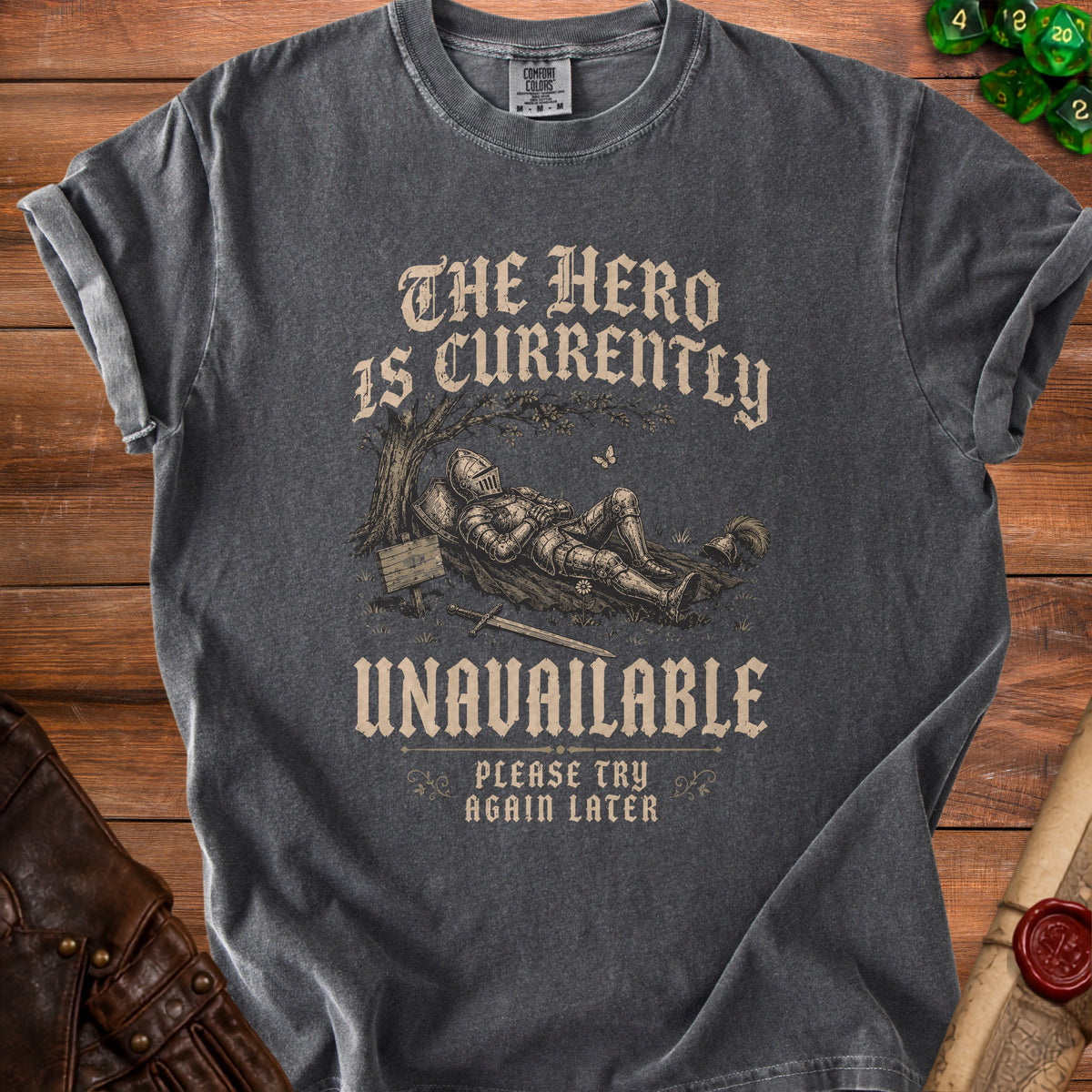 Dark grey t-shirt with knight illustration and text "The hero is currently unavailable. Please try again later."